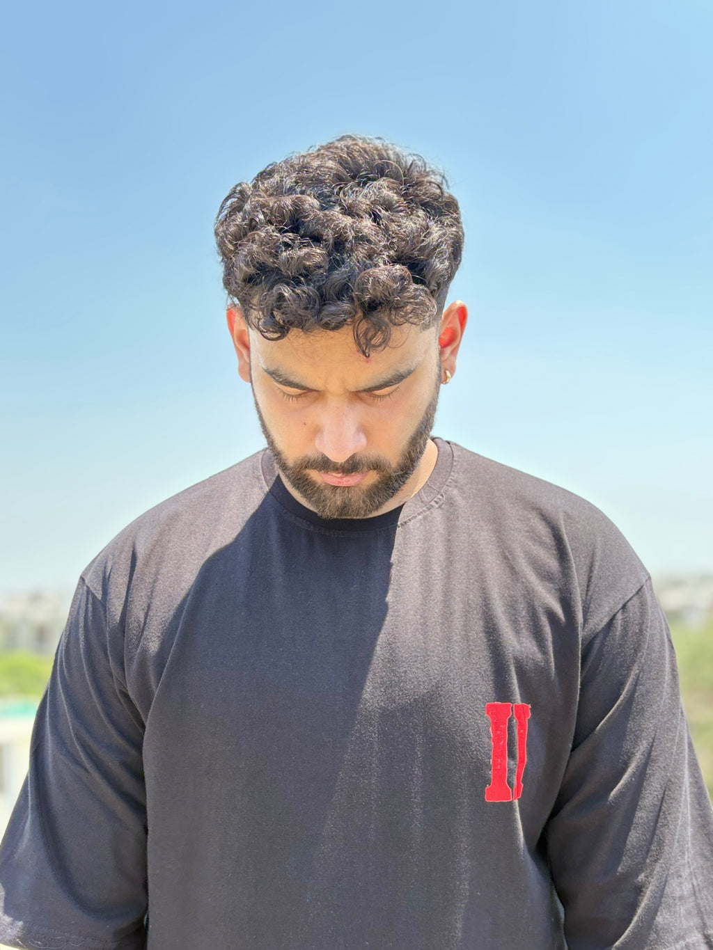 Person wearing the Blood Moon Cowboy oversized graphic T-shirt in black