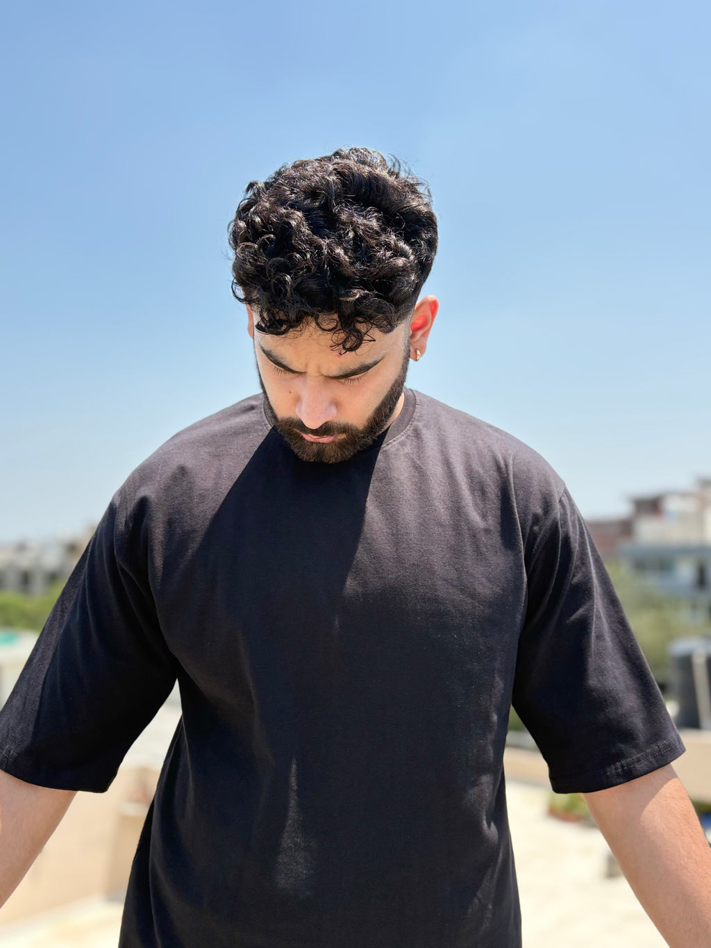 Person wearing The Artist Within oversized graphic T-shirt in black